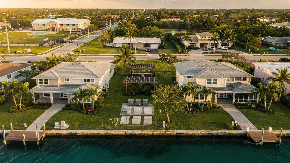 Two Miami-Dade homes with different waterfront access, utilities, roads, drainage, school proximity, and surrounding service conditions